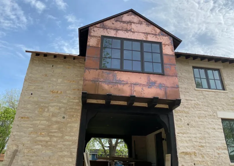 Copper metal panel facade on a stone building for Metal Roof Coating in Elba